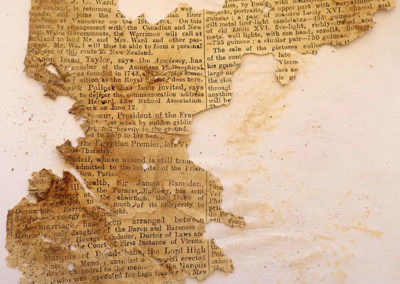 Fragmento de periódico en inglés, probablemente de finales del siglo XIX o comienzos del XX, hallado en la zona de la capilla de adobe.