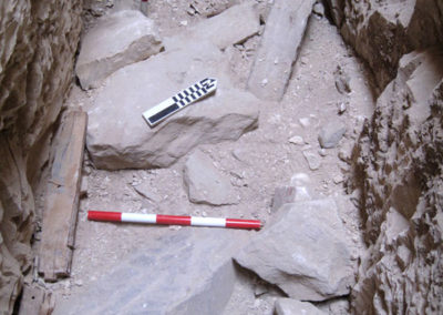 Fragmentos de piedra, algunos con inscripción, en el fondo del pozo de José Miguel.