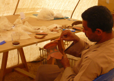 Mohamed junta los fragmentos de una gran vasija decorada que ha ido saliendo en el pozo del mudir.