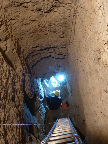 Al fondo del pozo funerario de Hery, Salima y Hassan excavan la cámara de las momias de ibis y halcones.