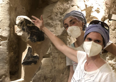Lucía y Alba colocan en su sitio un fragmento de la tumba de Djehuty hallado en la excavación de fuera.